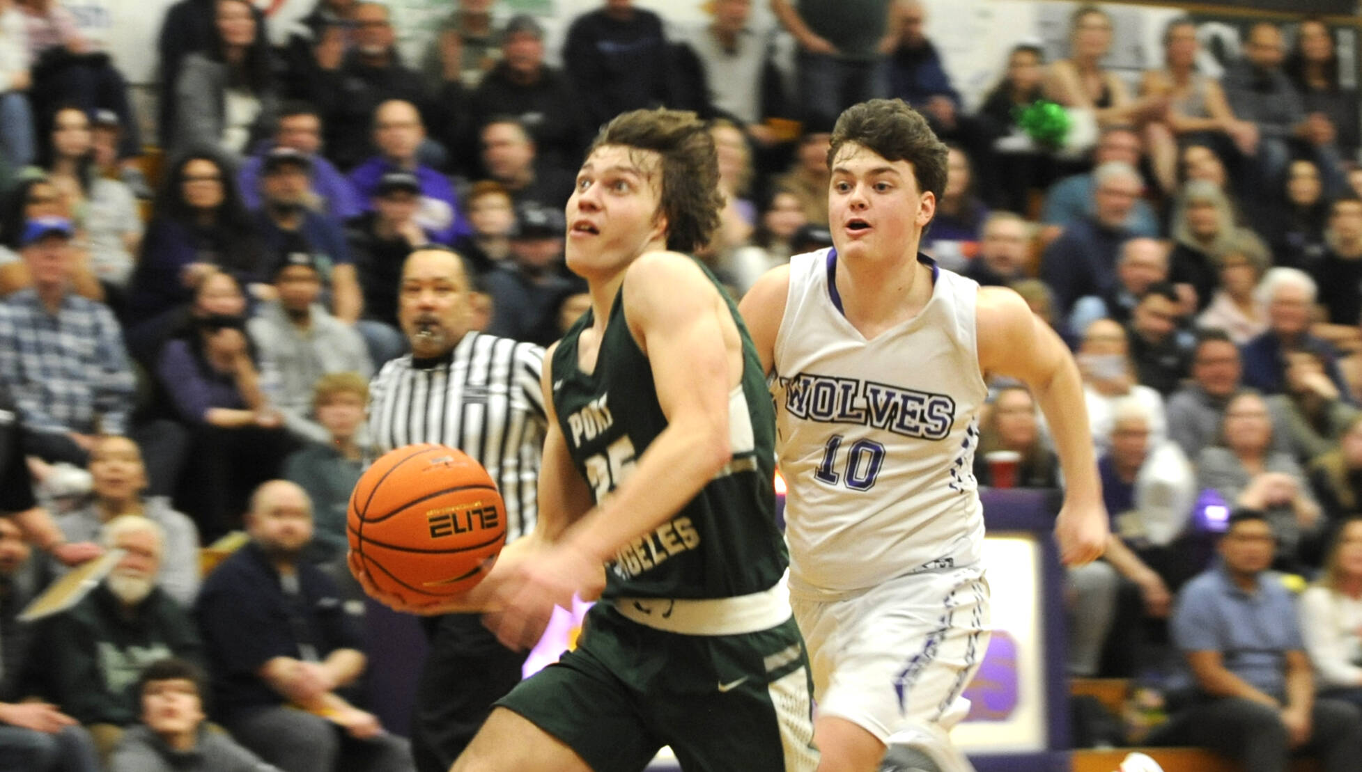 Michael Dashiell/Olympic Peninsula News Group
Port Angeles' Parker Nickerson eyes the rim on a breakaway while chased by Sequim's Keenan Greene. Nickerson is the 2022-23 All-Peninsula Boys Basketball MVP.