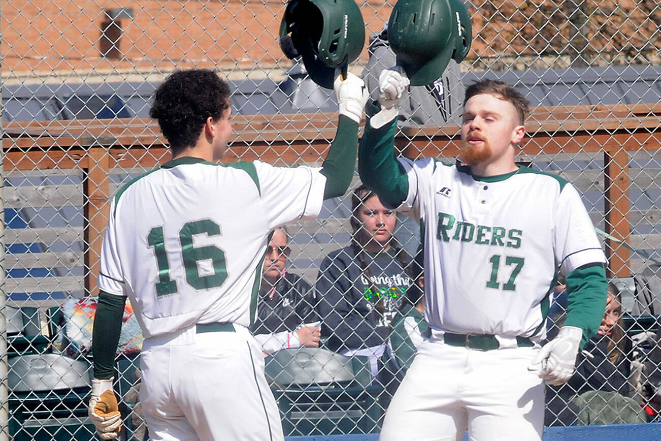 KEITH THORPE/PENINSULA DAILY NEWS
Port Angeles' Ezra Townsend, right, is greeted at home plate by teammate Kaleb Mullen after Townsend batted a solo homer in the third inning against South Whidbey on Tuesday in Port Angeles.