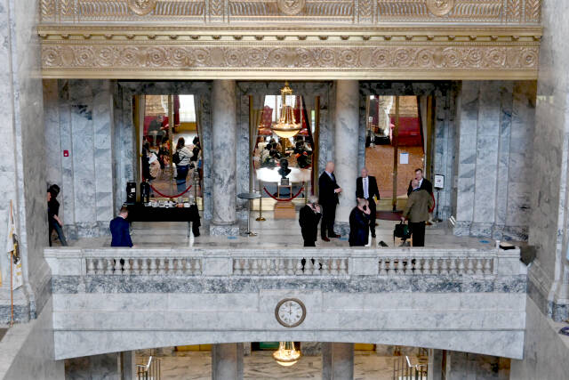 Lawmakers gather outside the State Reception Room on the second floor of the state Capitol. The legislative session ends April 23. (Paul Gottlieb/for Peninsula Daily News)