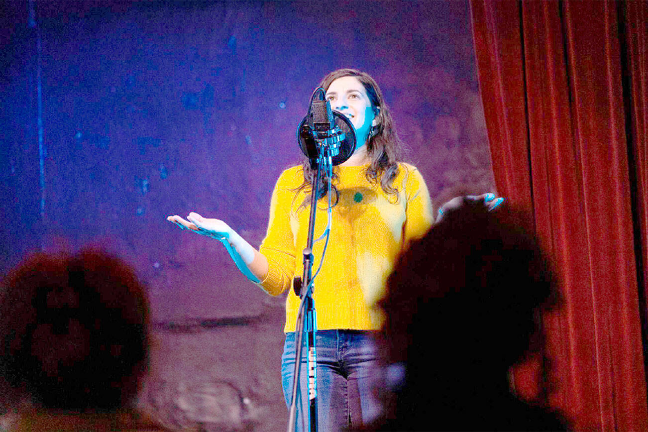 Elizar Mercado Nessa Goldman, host of the Out Loud Story Slam, tells a story at The Jewel Box Theatre in Poulsbo.