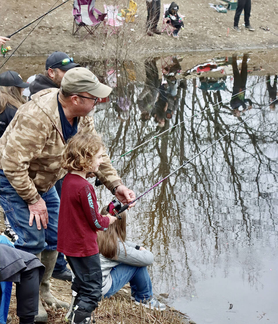 Finnegan Mosely, 6, is helped by his grandfather Roger Mosely at the Kid’s Fishing Derby held Saturday at the Lincoln Park pond. (Dave Logan/for Peninsula Daily News)