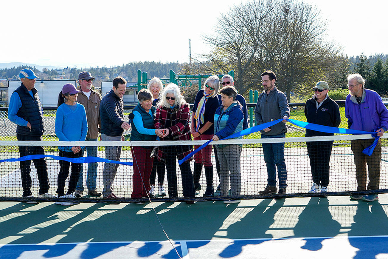 Steve Mullensky/for Peninsula Daily News


Port Townsend city council member, Monica Mick-Hagger and Port Townsend Pickleball Club president Lynn Pierle (cq) cut the ribbon to dedicate the Mountain View Pickleball courts to the City of Port Townsend in a ribbon cutting on Wednesday at the club. Others looking on are members of the club board of directors and city manager John Mauro, holding the microphone, Carrie Hite, Director of Parks and Recreation strategy, holding the ribbon and to her left is director of parks facilities, Michael Todd. The club now has 219 members on the roster.
