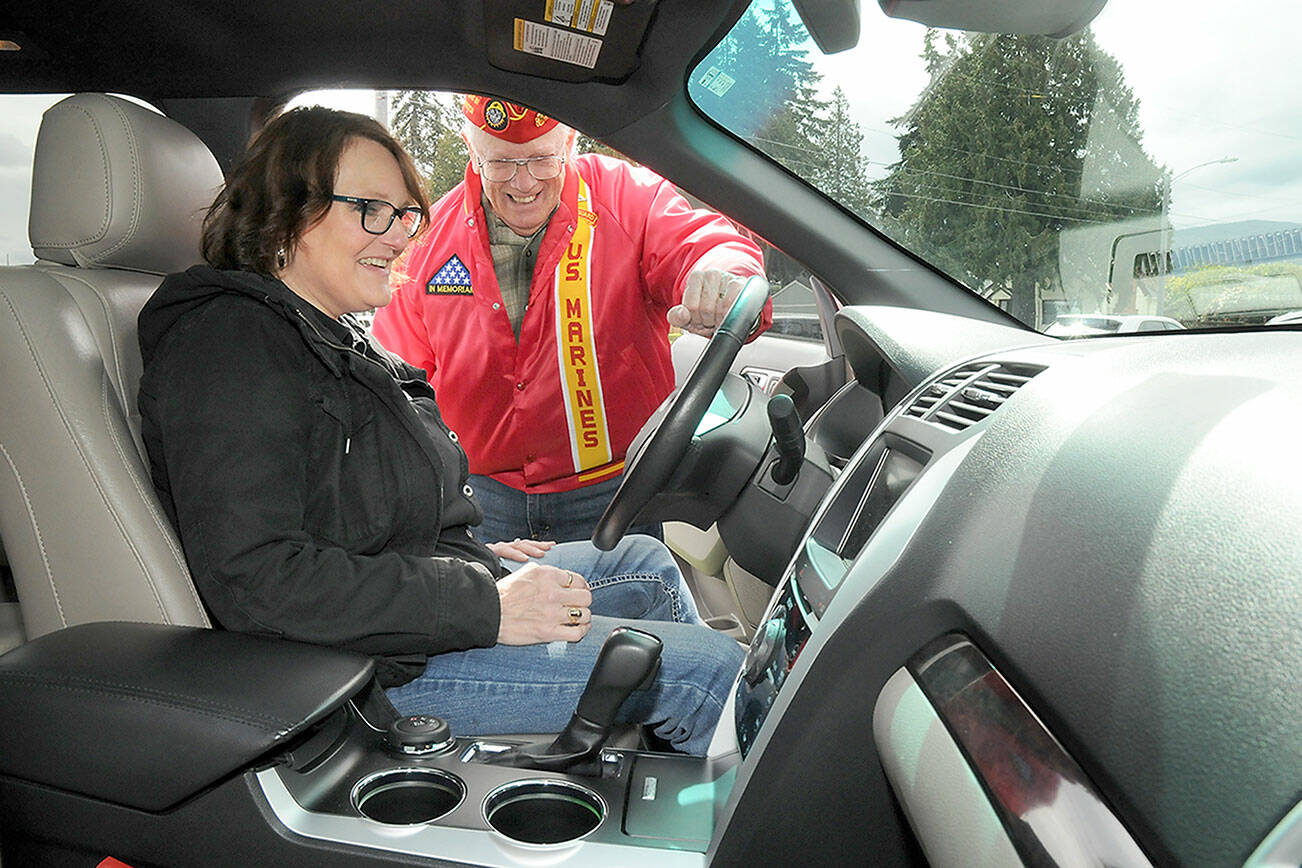 KEITH THORPE/PENINSULA DAILY NEWS
Cheri Tinker, executive director of Forks-based Sarge's Veterans Support, front, looks over the features of a donated van with Mark Schildknecht, commandant of Mount Olympus Detatchmet 897 of the Marine Corps League after turning over the keys on Thursday at the Northwest Veterans Resource Center in Port Angeles. The 2013 Ford Explorer van, donated by the Marine Corps League, will be used by the North Olympic Regiional Veteran's Housing Network for ferrying Forks-area vets to and from medical appointments and for veterans outreach services.