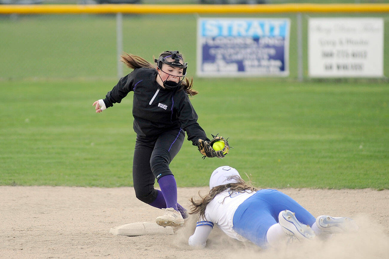 Michael Dashiell/Olympic Peninsula News Group
Sequim shortstop Hannah Bates, left, puts the tag on an Olympic runner in an April 13 league match-up in Sequim.