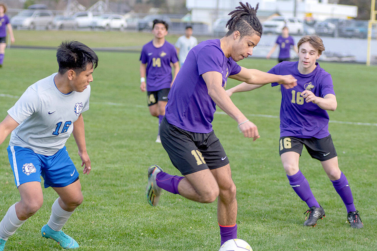 Emily Matthiessen/Olympic Peninsula News Group
Sequim's Mekhi Ashby possesses the ball while teammate James Mason, right, looks on during the Wolves' 2-1 win over North Mason on Thursday.