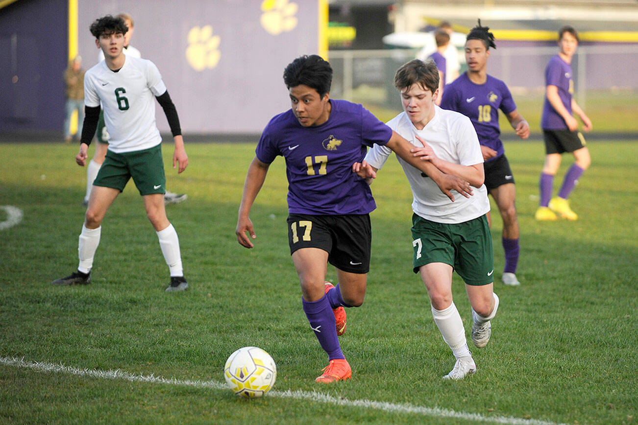 Michael Dashiell/Olympic Peninsula News Group
Sequim's Abe Torres, left, vies with Port Angeles' Kaleb Gagnon during the Wolves' 1-0 win over the Roughriders on Tuesday.