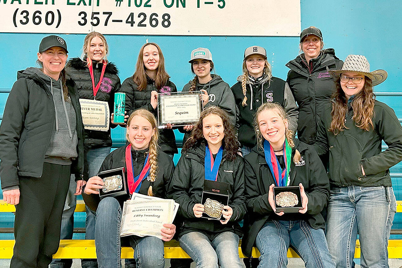 Sequim’s high school equestrian team celebrates taking home the district 4 small teams Championship, along with belt buckles and medals at the end of their final district WAHSET competition. The team’s high scores also earned them 24 qualifying placements to compete at the State Finals in May. Standing from left: Coach Katie Newton, Celbie Karjalainen, Katelynn Sharpe, Lily Meyer, Kennady Gilbertson, Coach Bettina Hoesel, Assistant Coach Keri Tucker. Sitting from left: Libby Swanberg, Sydney Hutton, Paige Reed.

Photo submitted by Katie Newton