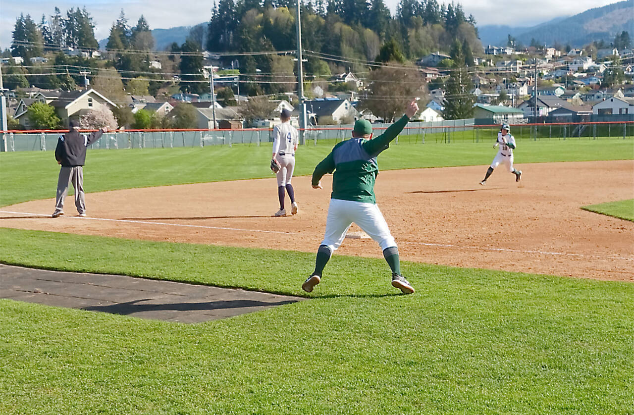 Port Angeles coach Zac Moore waves baserunner Josiah Gooding around third base for a run after a Colton Romero double at Civic Field on Tuesday. Despite a big four-run second inning, Bainbridge beat Port Angeles 13-3. (Pierre LaBossiere/Peninsula Daily News)