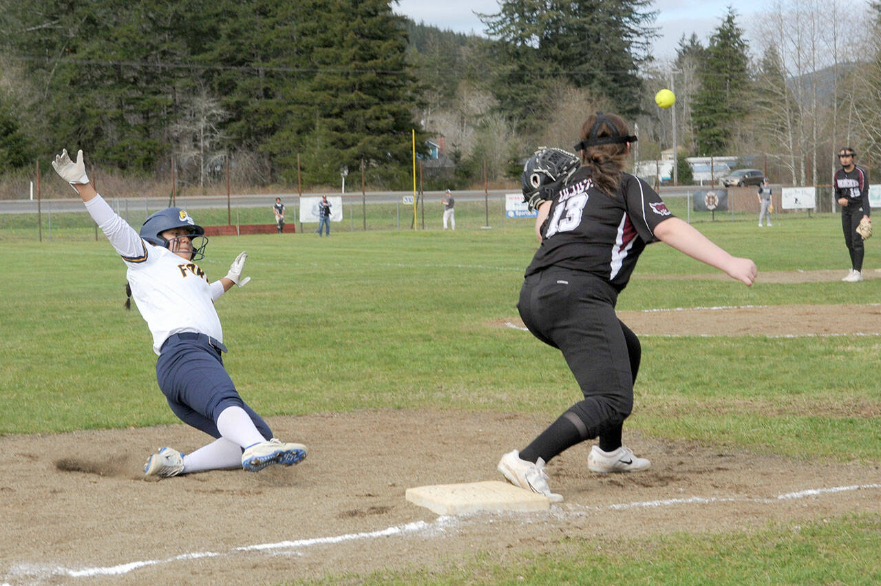 Lonnie Archibald/for Peninsula Daily News Forks Elizabeth Soto steals third during the first game of a double header at the Fred Orr Memorial Park in Beaver with Pacific League opponent Ocosta.