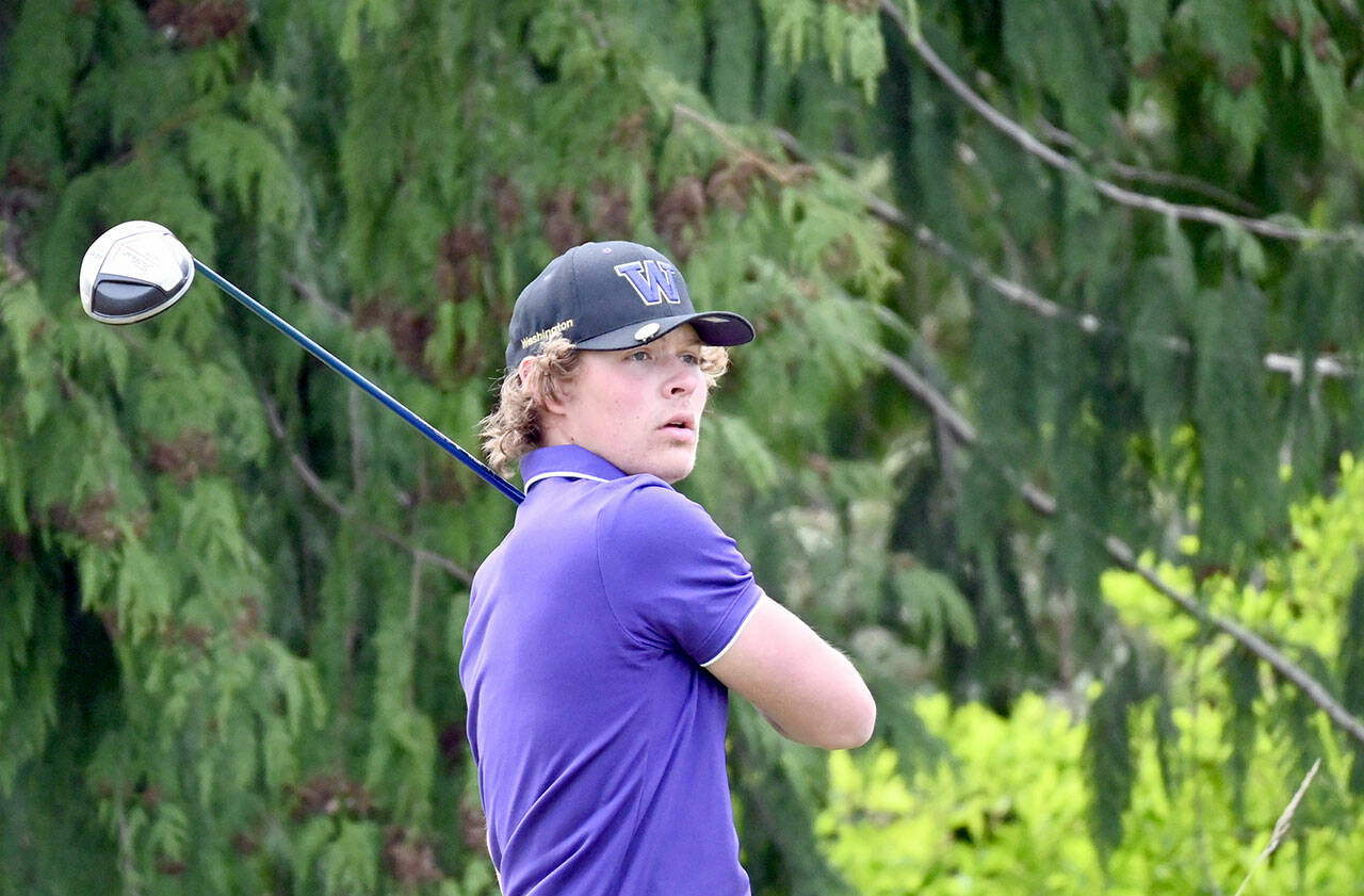 Michael Dashiell/Olympic Peninsula News Group Sequim’s Zack Thompson tees off during a match against Olympic played Wednesday at The Cedars at Dungeness.