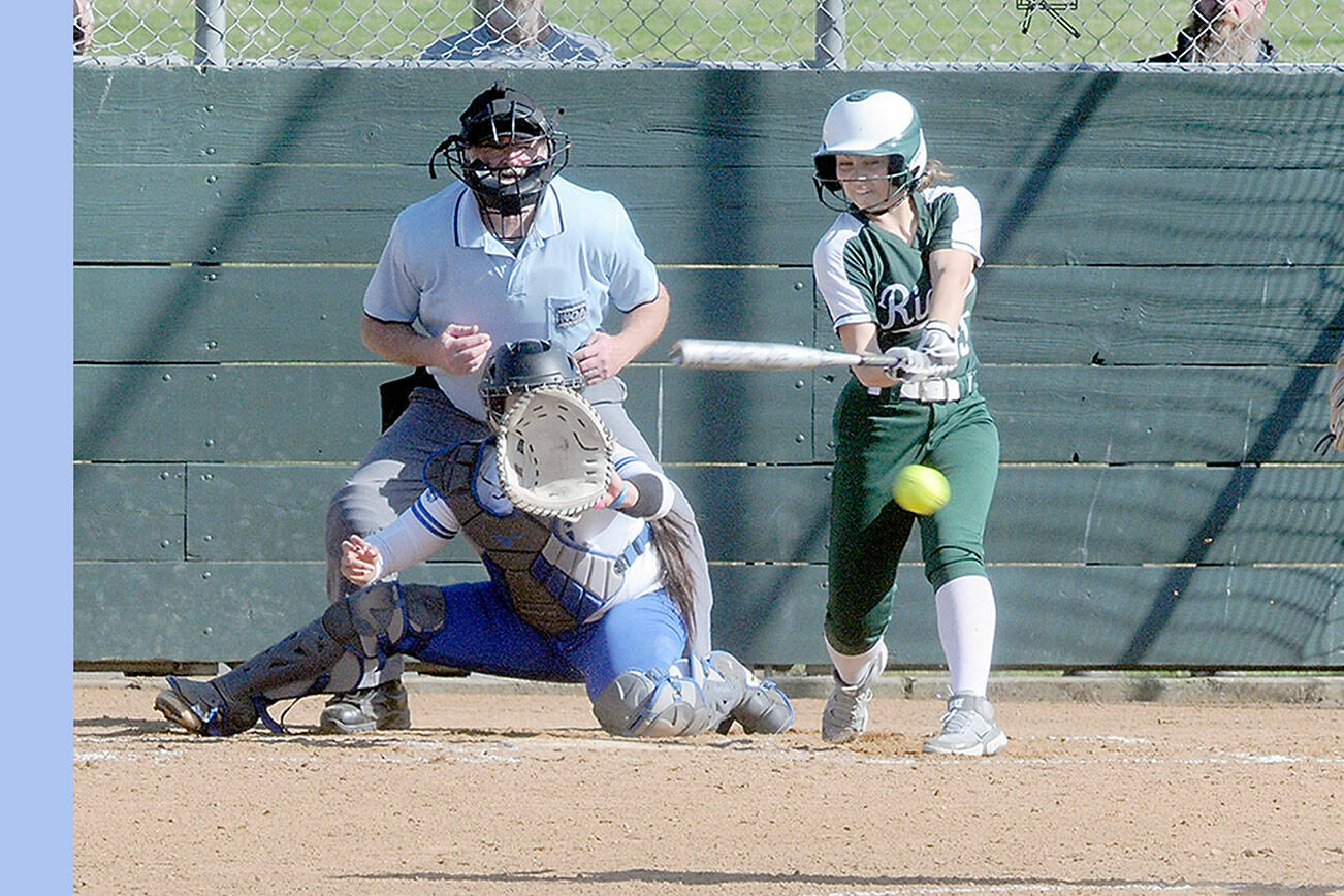 KEITH THORPE/PENINSULA DAILY NEWS
Port Angeles' Kennedy Rognlien swings for a triple in the third inning as Olympic catcher Beya Richmond waits for the delivery from pitcher Brenda Morrison on Thursday at Dry Creek Elementary in Port Angeles.