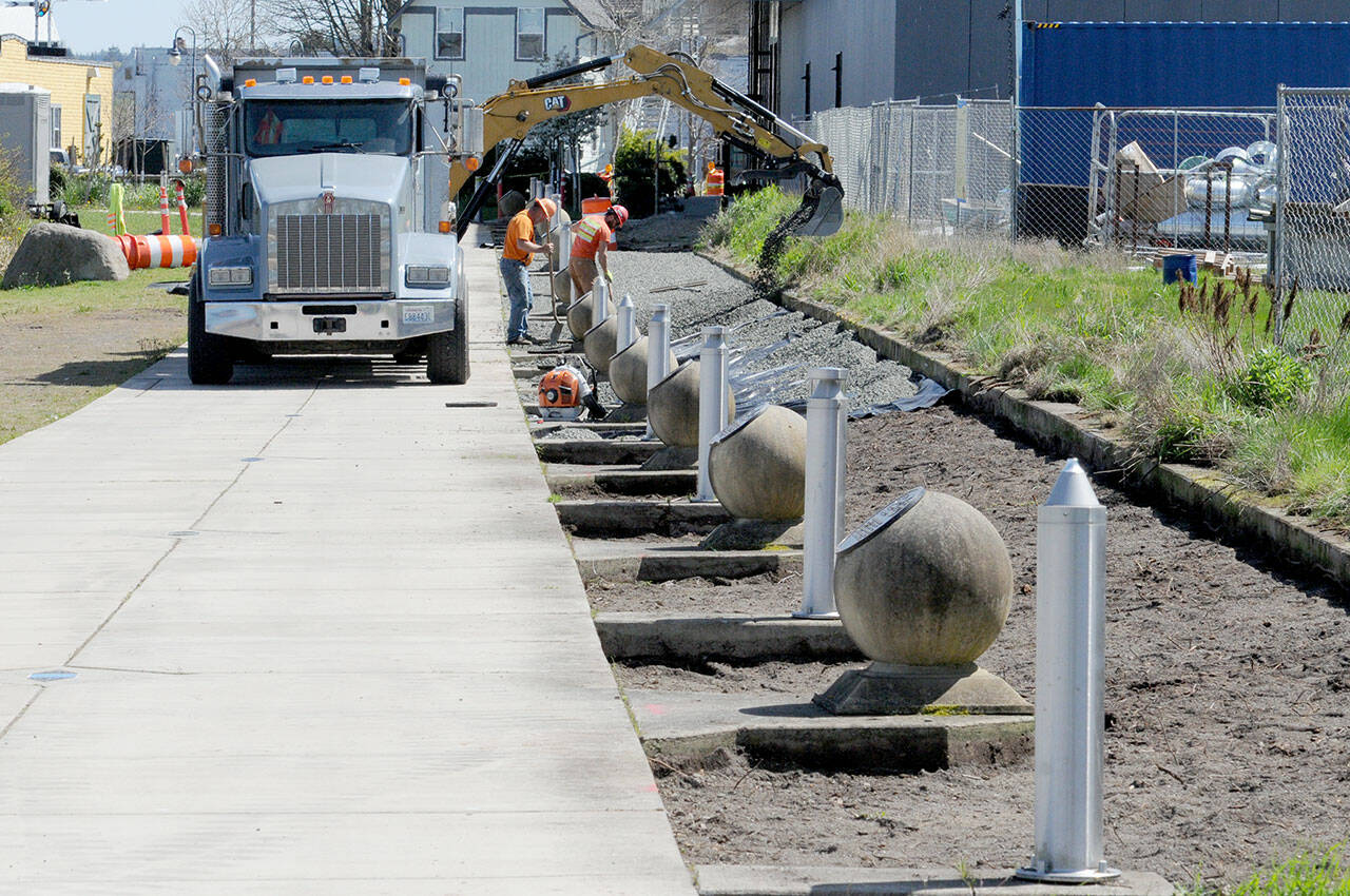 A construction crew performs landscape work along a portion of the Waterfront Trail, part of the Olympic Discovery Trail, at Pebble Beach Park on Friday near downtown Port Angeles. (KEITH THORPE/PENINSULA DAILY NEWS)