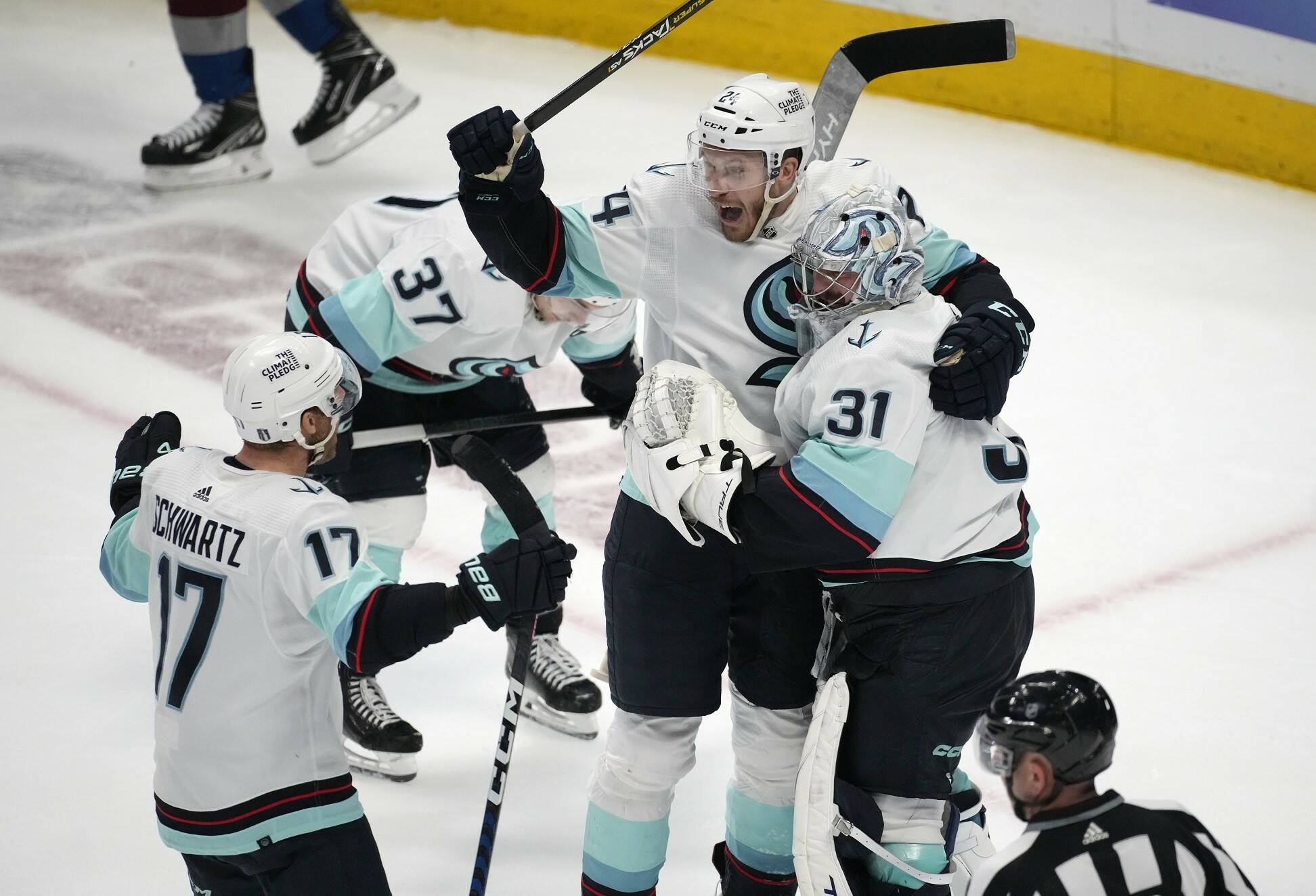 From left, Seattle Kraken center Jaden Schwartz, defenseman Jamie Oleksiak and goaltender Philipp Grubauer celebrate as time runs out in the third period of Game 7 of an NHL first-round playoff series against the Colorado Avalanche Sunday, April 30, 2023, in Denver. The Kraken won 2-1 to advance to round two of the Stanley Cup Playoffs against the Dallas Stars. (AP Photo/David Zalubowski)