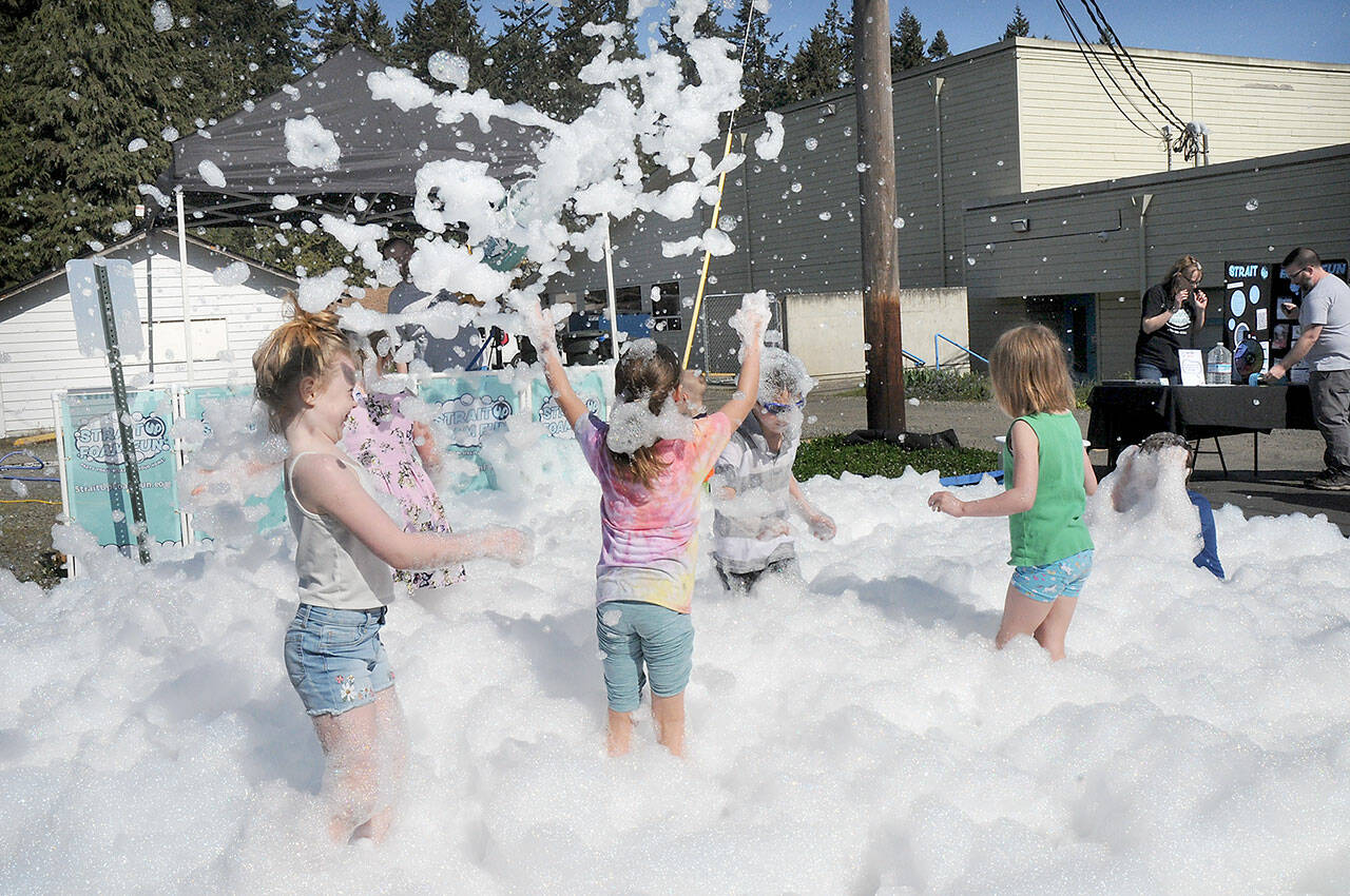 Children cavort in a sea of foam as an activity for Healthy Kids Day on Saturday at the YMCA of Port Angeles. The event featured a variety of youth activities designed to promote a healthy lifestyle. (Keith Thorpe/Peninsula Daily News)