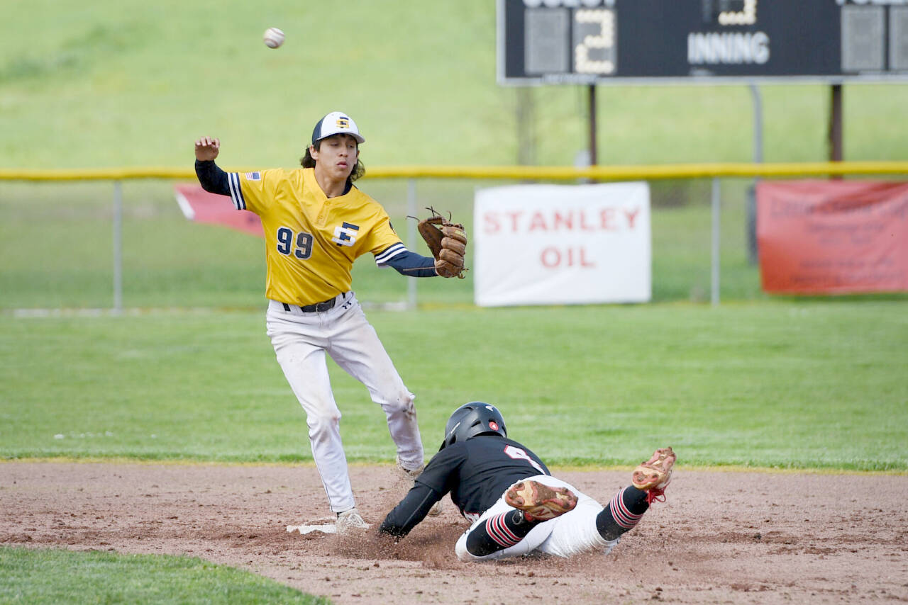 Wahkiakum’s Dom Curl slides into second base as Forks’ Aiden Salazar (99) covers the base during a 2B District IV playoff baseball game at Bowen Field in Toledo on Saturday. Forks won 6-5 in a walkoff in the eighth inning. (Katelyn Metzger/The Daily News)