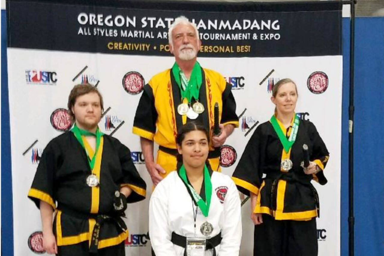 These members of the White Crane Martial Arts school in Port Angeles won medals at the Northwest Regional Hanmadang Championships in Eugene, Ore., this past weekend. Top center is school Grandmaster Robert Nicholls; left is Zach Irving, right is Connie Irving and bottom center is Annabelle Norcross from White Crane affiliate school Cross Martial Arts in Poulsbo. (Courtesy photo)