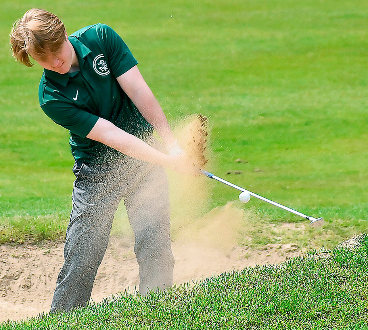 Port Angeles golfer Nate Anderson escapes a sand trap during the Olympic League Golf Championships at Kitsap Golf & Country Club on Monday. (Nicholas Zeller-Singh/Kitsap News Group)