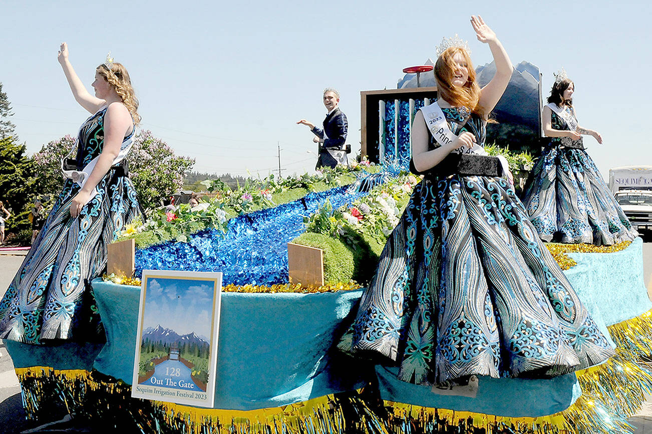 Sequim Irrigation Festival royalty, from left, Princess Paige “Skylar” Krzyworz, Prince Fred Cameron, Princess Anne Marie Barni and Queen Pepper Reymond preside over the festival from their float in Saturday’s Grand Parade. (Keith Thorpe/Peninsula Daily News)