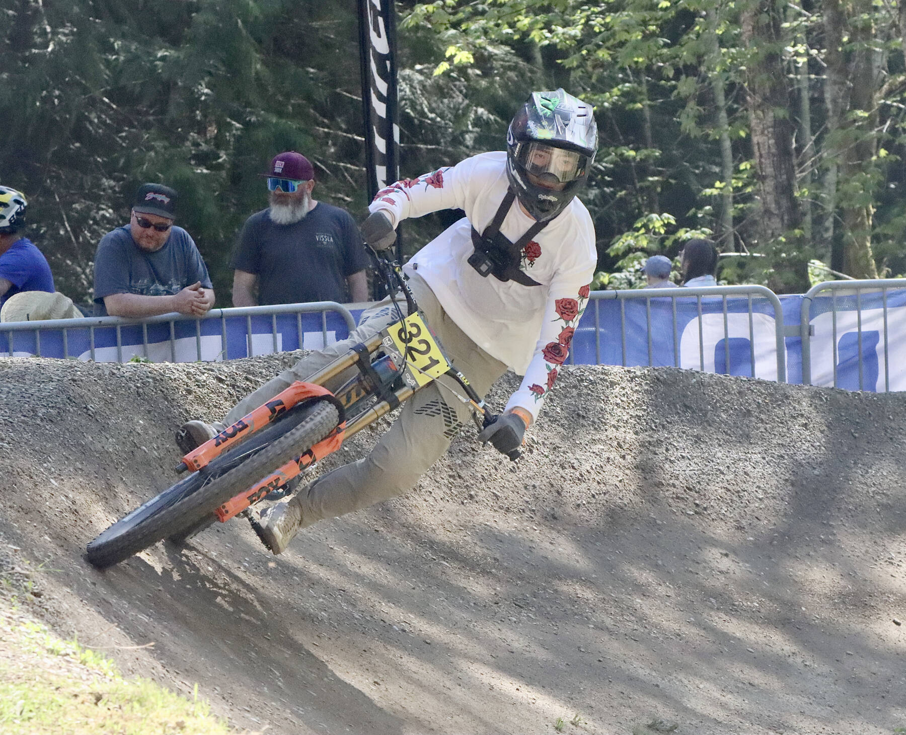 Dave Logan/for Peninsula Daily News
Cullen Ren of Burnaby, B.C. flies around the last banked corner before the finish on the downhill race course for the Northwest Cup on Dry Hill west of Port Angeles on Sunday. Cullen, age 20, was racing in the K2 class. More than 500 bike riders came out to the course on Saturday and Sunday for the second race of the Northwest Cup. For results and more photos, look in Tuesday's Peninsula Daily News sports section.