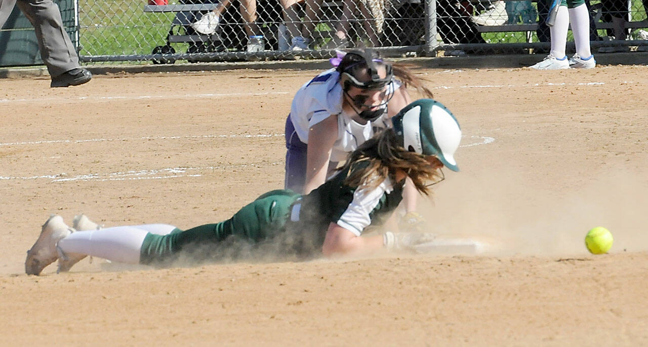 Port Angeles baserunner Lily Halberg makes a diving slide into second as the ball gets past Sequim shortstop Hannah Bates last week in Port Angeles. Both teams begin play in the bi-district tournament Friday. (Keith Thorpe/Peninsula Daily News)