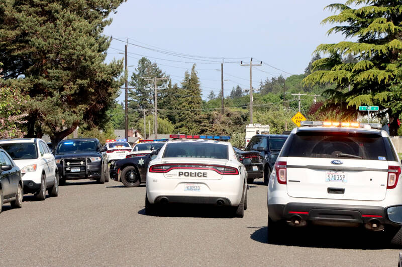 Law enforcement agencies respond Tuesday afternoon to a standoff at Lopez Avenue and Vine Street in Port Angeles. (Dave Logan/for Peninsula Daily News)