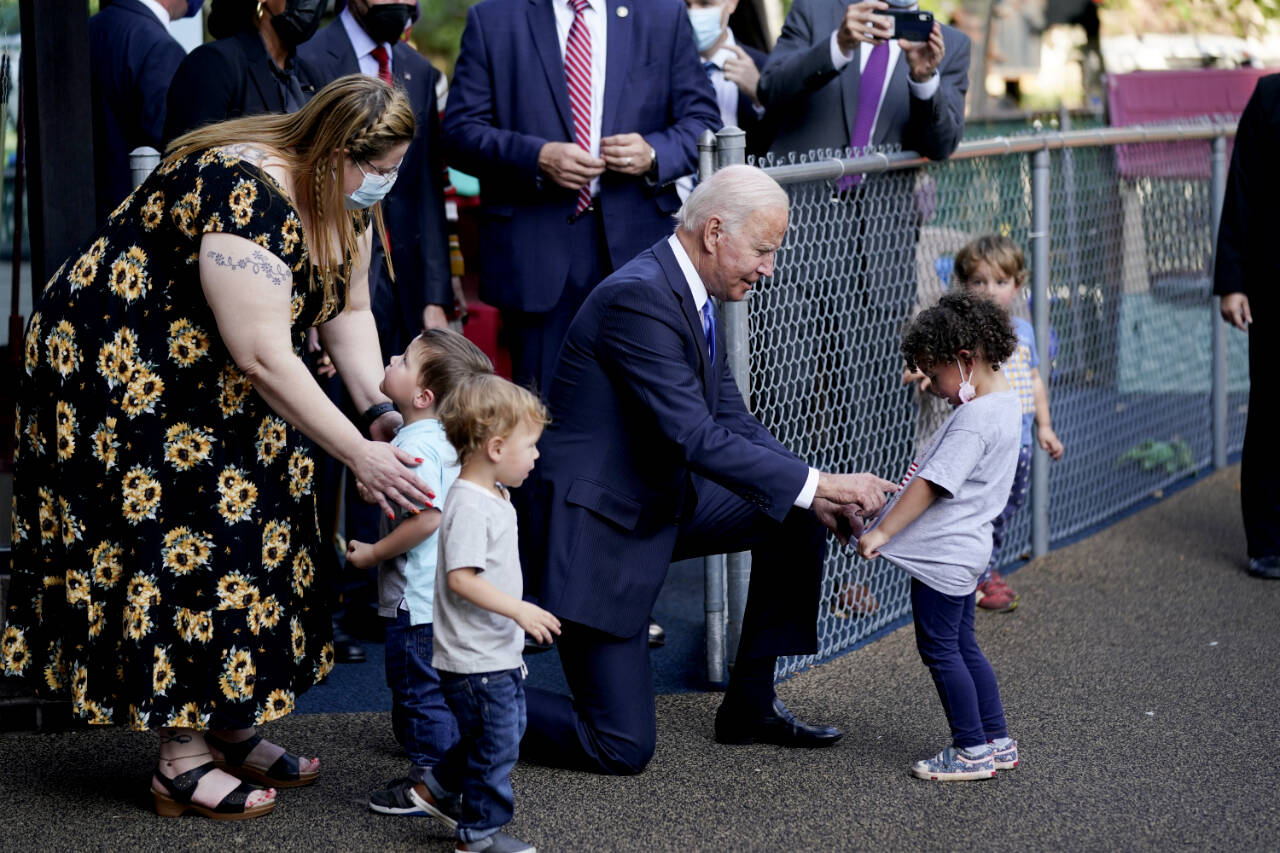 President Joe Biden greets children as he visits the Capitol Child Development Center, Oct. 15, 2021, in Hartford, Conn. On Friday, The Associated Press reported on a photo circulating online that was manipulated to make it appear that Biden was touching a child inappropriately below the waist. (AP Photo/Evan Vucci, File)