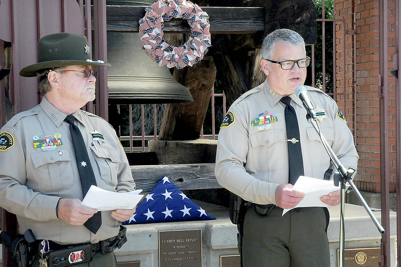 KEITH THORPE/PENINSULA DAILY NEWS
Clallam County Sheriff Brian King, right, speaks about the service of law enforcement personnel as Sgt. (Ret.) Randy Pieper listens in during Friday's bell-ringing ceremony on National Peace Officer Memorial Day at Veteran's Park in Port Angeles. The event was part of National Police Week to pay tribute to officers how ave lost their lives in the line of duty.