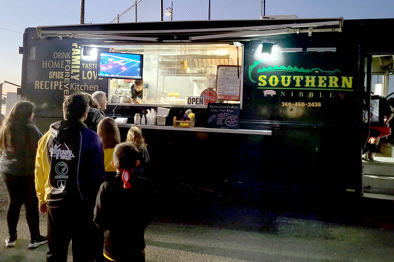 Caleb Messinger and staff with the Southern Nibble food truck serve customers at a Sequim High School soccer game in September 2022. (Michael Dashiell/Olympic Peninsula News Group)