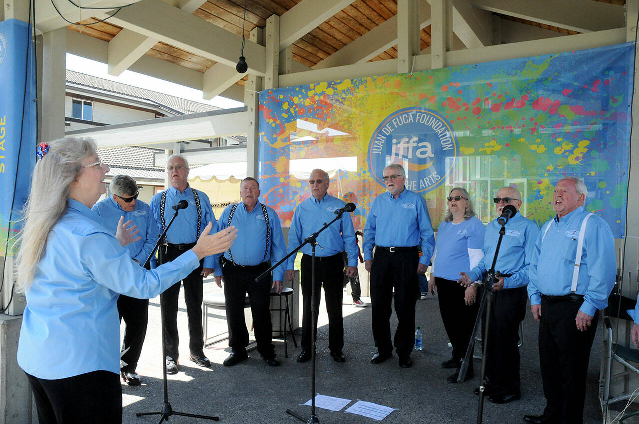 Members of Juan de Fuca Harmony, under the direction of Linda Muldowney, left, perform barbershop-style music on the outdoor Community Stage of the Juan de Fuca Festival on Saturday. (Keith Thorpe/Peninsula Daily News)
