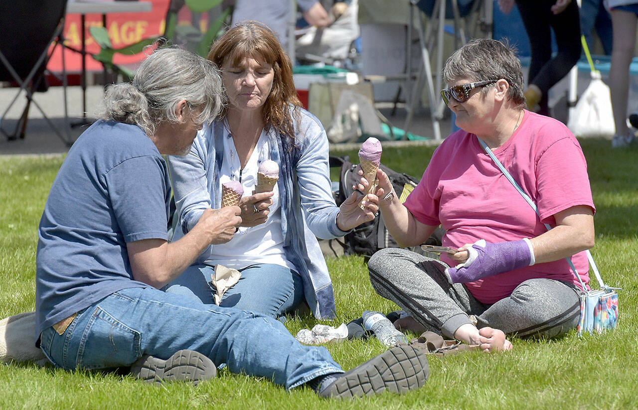 Terry McGinness, Kathleen O’Rourke and Tonya McGinness, all of Port Angeles, enjoy ice cream cones on the lawn of Vern Burton Community Center during Saturday’s session of the Juan de Fuca Festival in Port Angeles. (Keith Thorpe/Peninsula Daily News)