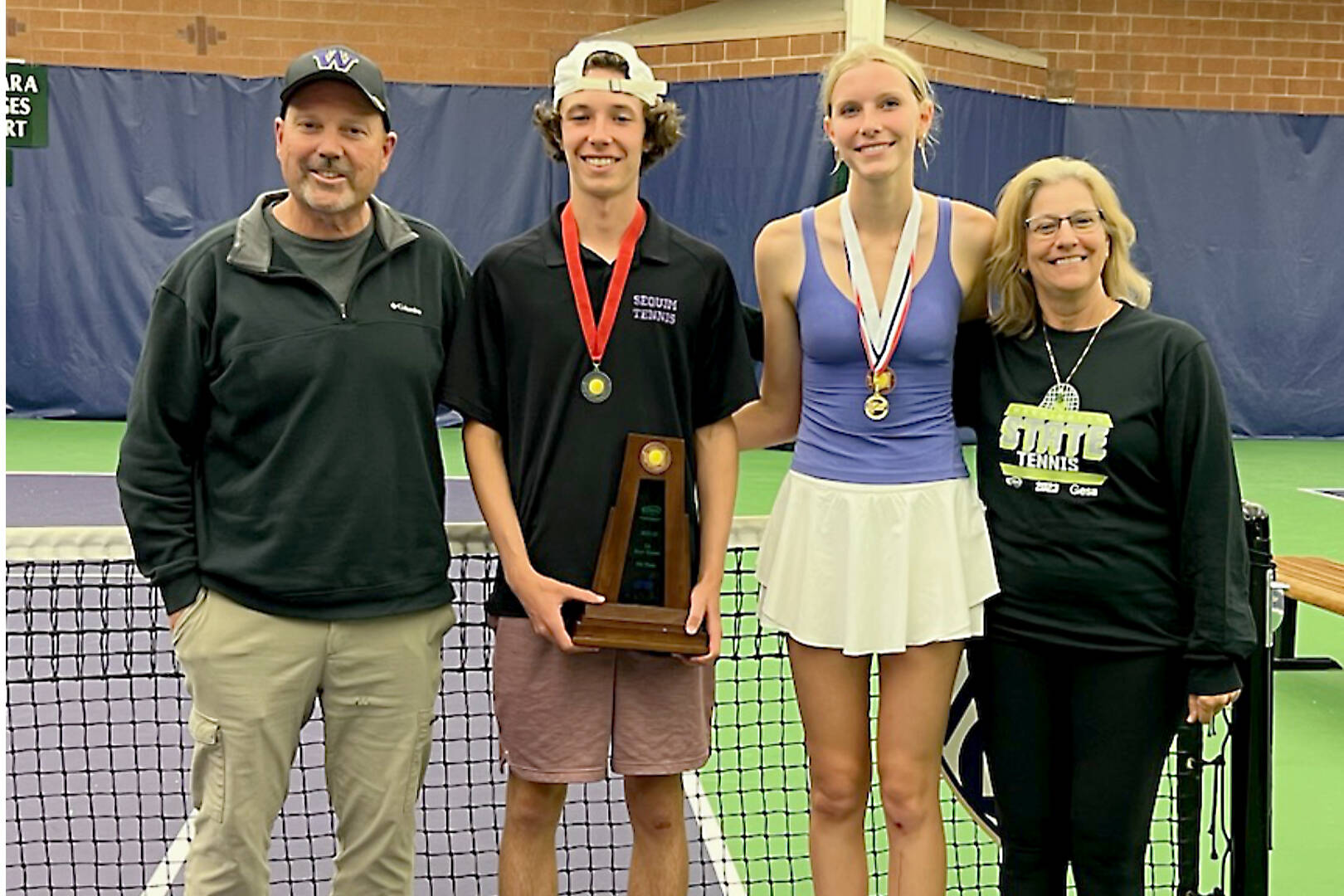 Sequim tennis coach Mark Textor, left celebrates Sequim's two high finishes at state second-place boys' finisher Garrett Little and third-place girls' finisher Kendall Hastings. Assistant coach Andrea Dietzman is at the right. (Courtesy photo).
