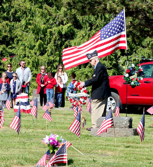 Gerald Rettela, representing Korean War veterans, lays a wreath as a part of Memorial Day ceremonies at Mt. Angeles cemetery on Monday. The ceremony was run by the Veterans of Foreign Wars Post 6787 Carlsborg. (Dave Logan/for Peninsula Daily News)
