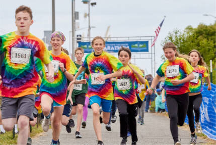 Kids take off during the annual kids’ marathon held at the Port Angeles City Pier in 2022. The kids’ marathon returns at 3 p.m. Saturday. (Cascadia Films)