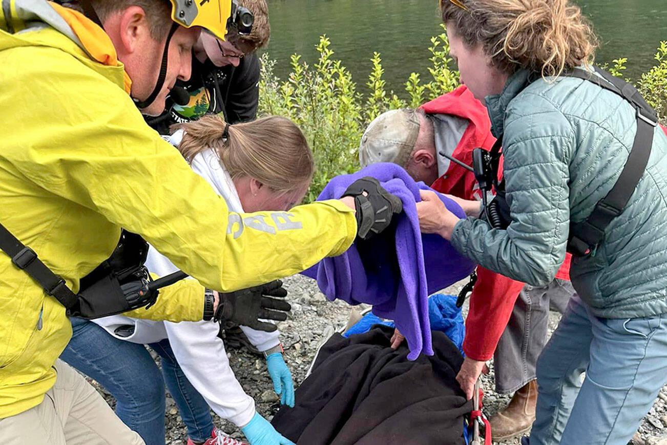 Rescuers in Jefferson County assist a woman on Wednesday who went looking for a hiker reported missing on Monday. The woman was injured attempting to cross the Duckabush River and transported to Jefferson Healthcare hospital in Port Townsend. (Brinnon Fire Department)