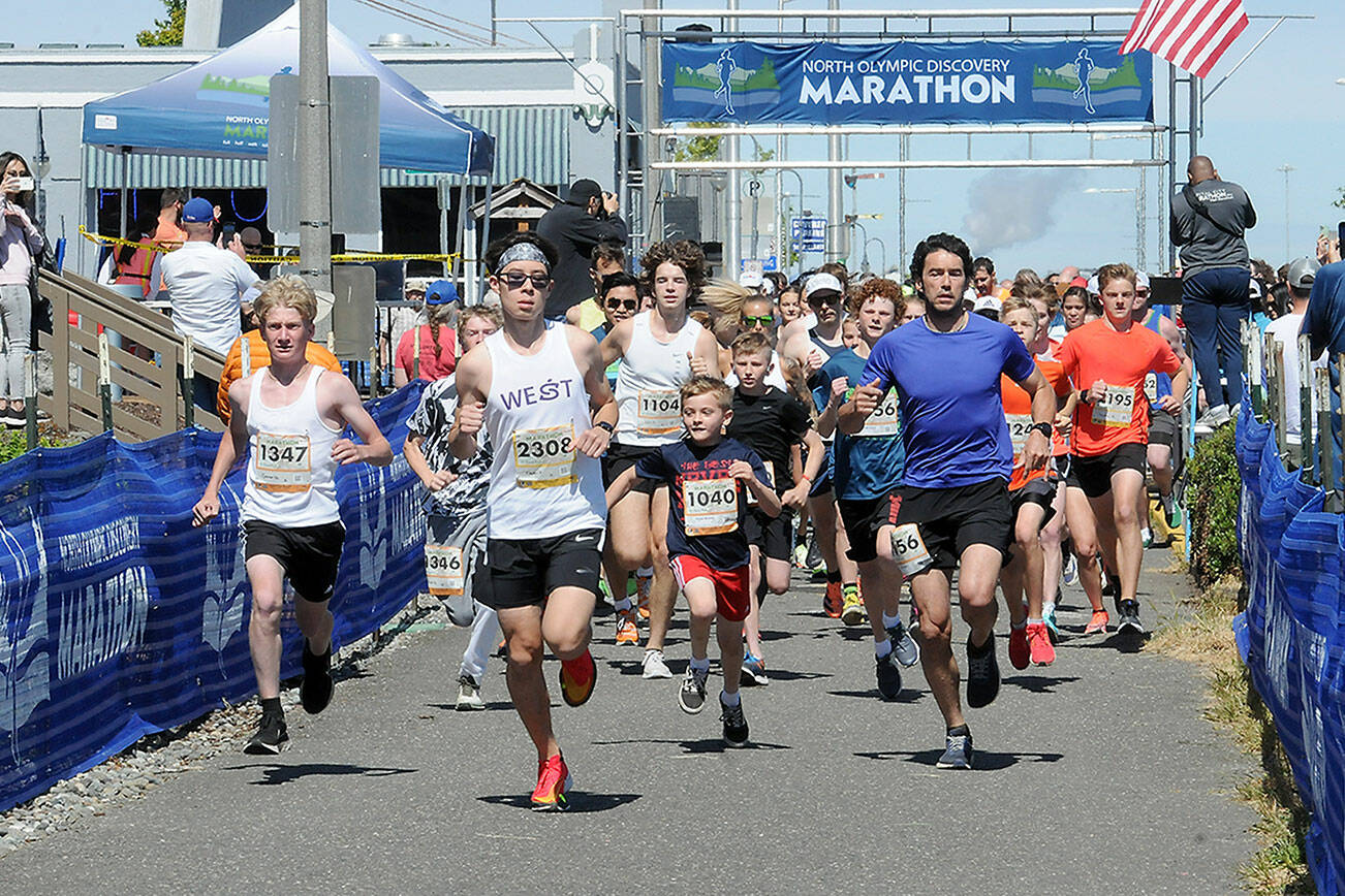 Runners take off from Port Angeles City Pier at the start of Saturday's combined 5k and 10k runs, the opening races of the Olympic Discovery Marathon. In the front center is the 10K winner Kaeden Peterson of Kingston. (Keith Thorpe/Peninsula Daily News)