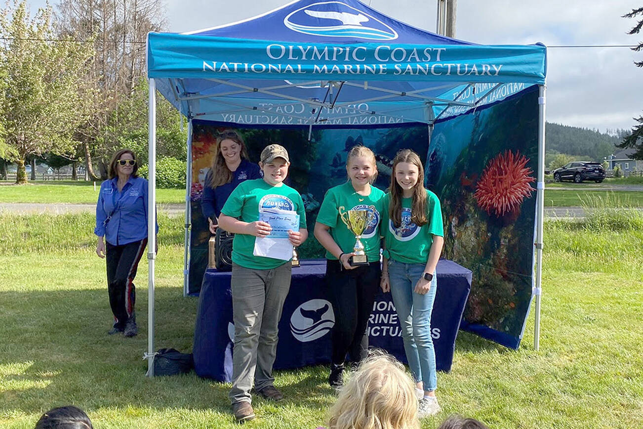 Photo Courtesy of NOAA

CAPTION: Members of the Forks Whales accept their trophy at the recent MATE ROV competition in Forks.