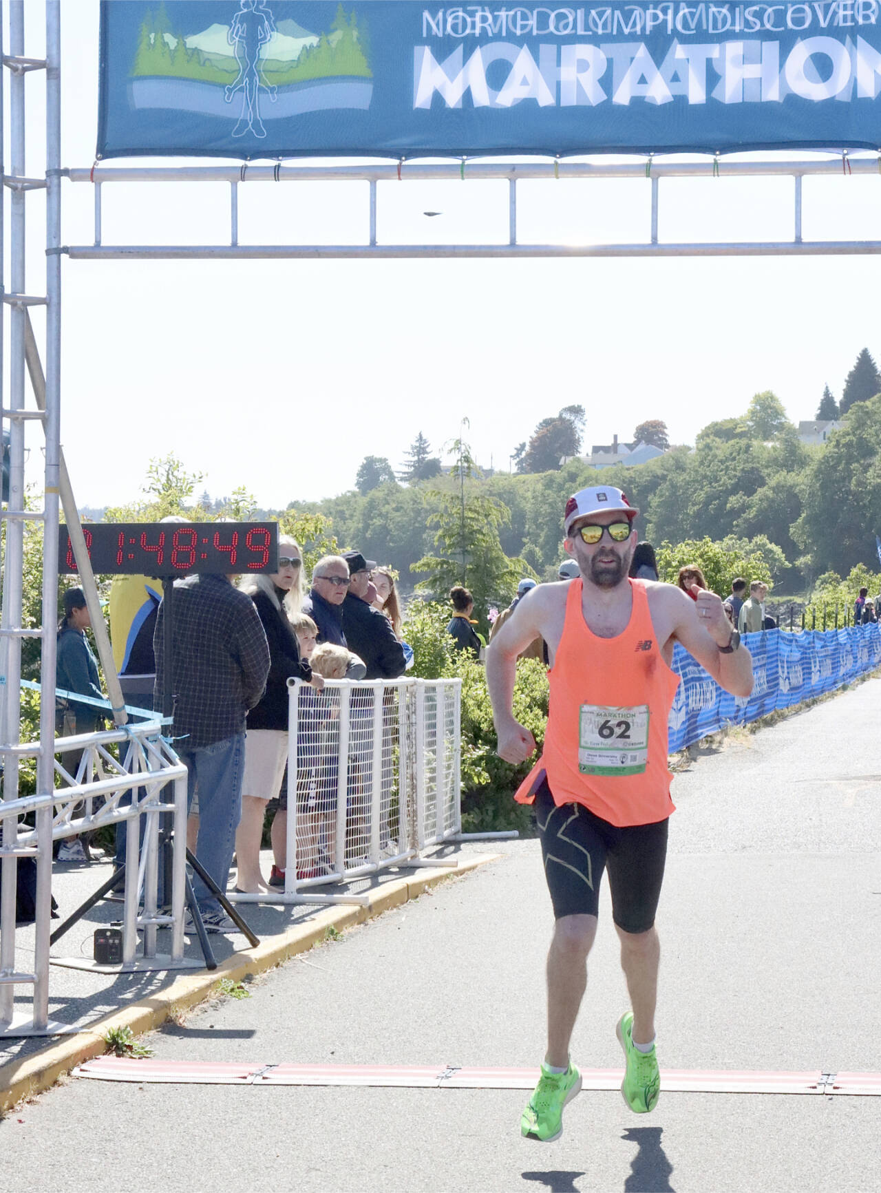 Derek Binnersley of Victoria, B.C., crosses the finish line as the winner of the North Olympic Discovery Marathon. Binnersley, running his first marathon, won in a time of 2 hours, 48 minutes, 47.51 seconds, winning by more than 5 minutes. (Dave Logan/for Peninsula Daily News)