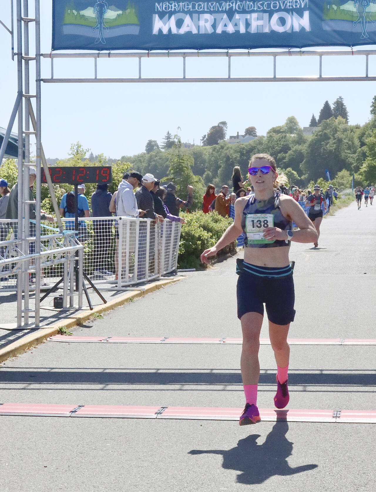 Sara King of Shoreline crosses the finish line of the North Olympic Discovery Marathon as the women’s winner in a time of 3:12:19.57, winning the women’s division by 17 minutes. (Dave Logan/for Peninsula Daily News)