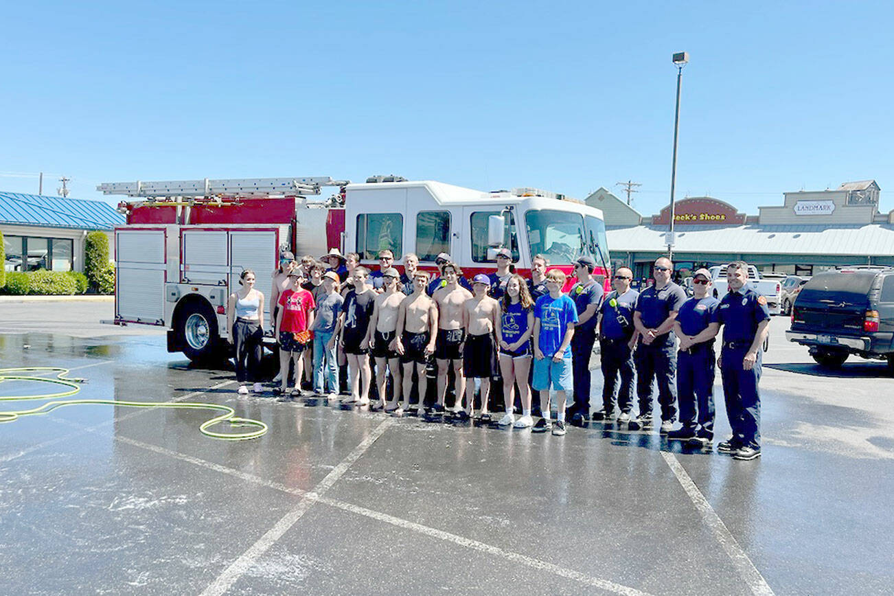 The duty crew from Clallam County Fire District #3 stopped in at the Sequim High School wrestling team’s car wash fundraiser on Saturday, June 3. 

Both teams are joined by the shared sorrow over the recent loss of District #3 Fire Captain/Sequim wrestling coach Chad Cate.