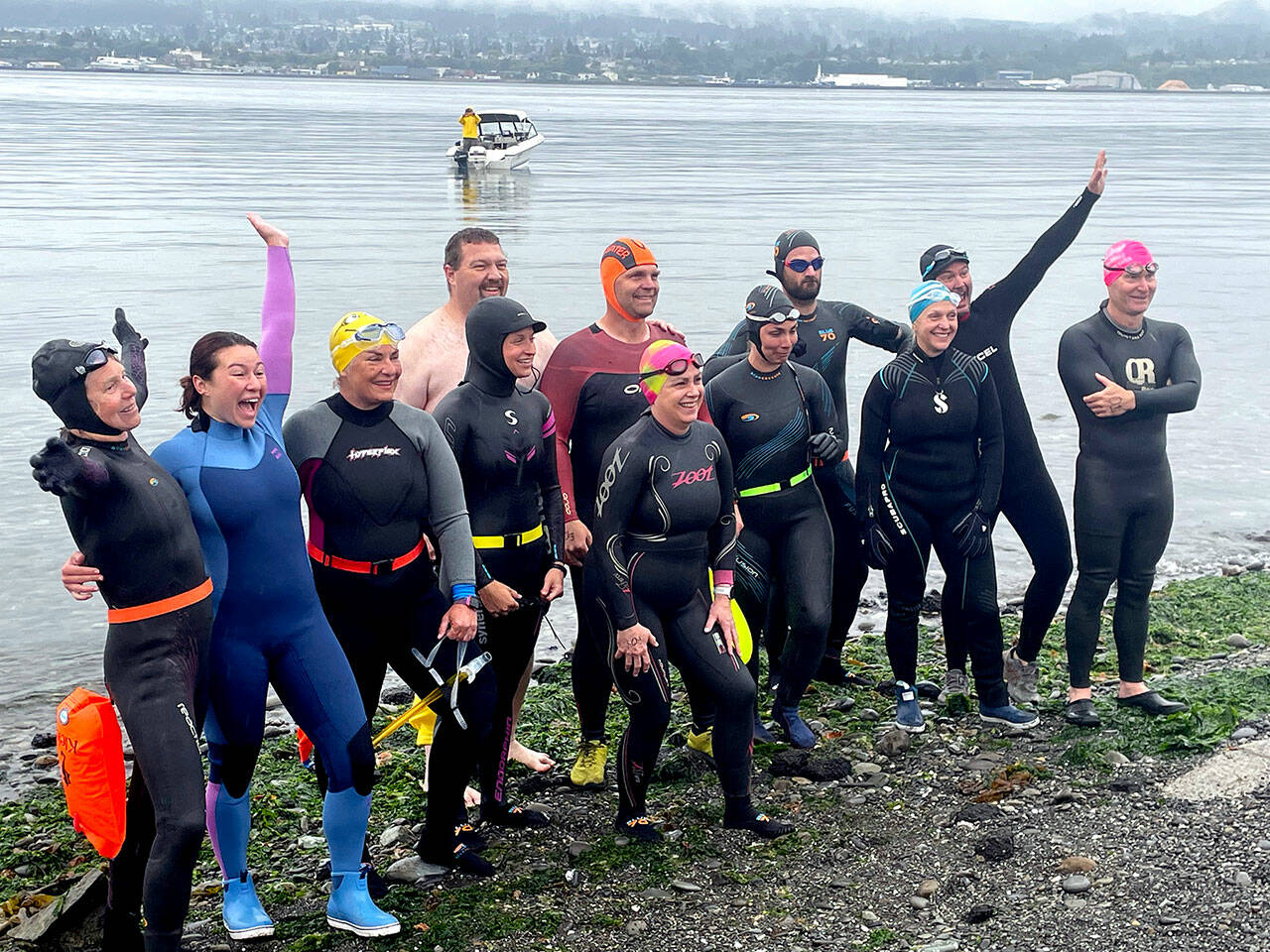 Participants in the Maritime Festival’s Orca Bait Swim pump themselves up on Ediz Hook before heading out across the harbor. The inaugural event drew 12 swimmers and three orcas, whose paths did not happen to meet over the 1 1/2-mile course. (Paula Hunt/Peninsula Daily News)