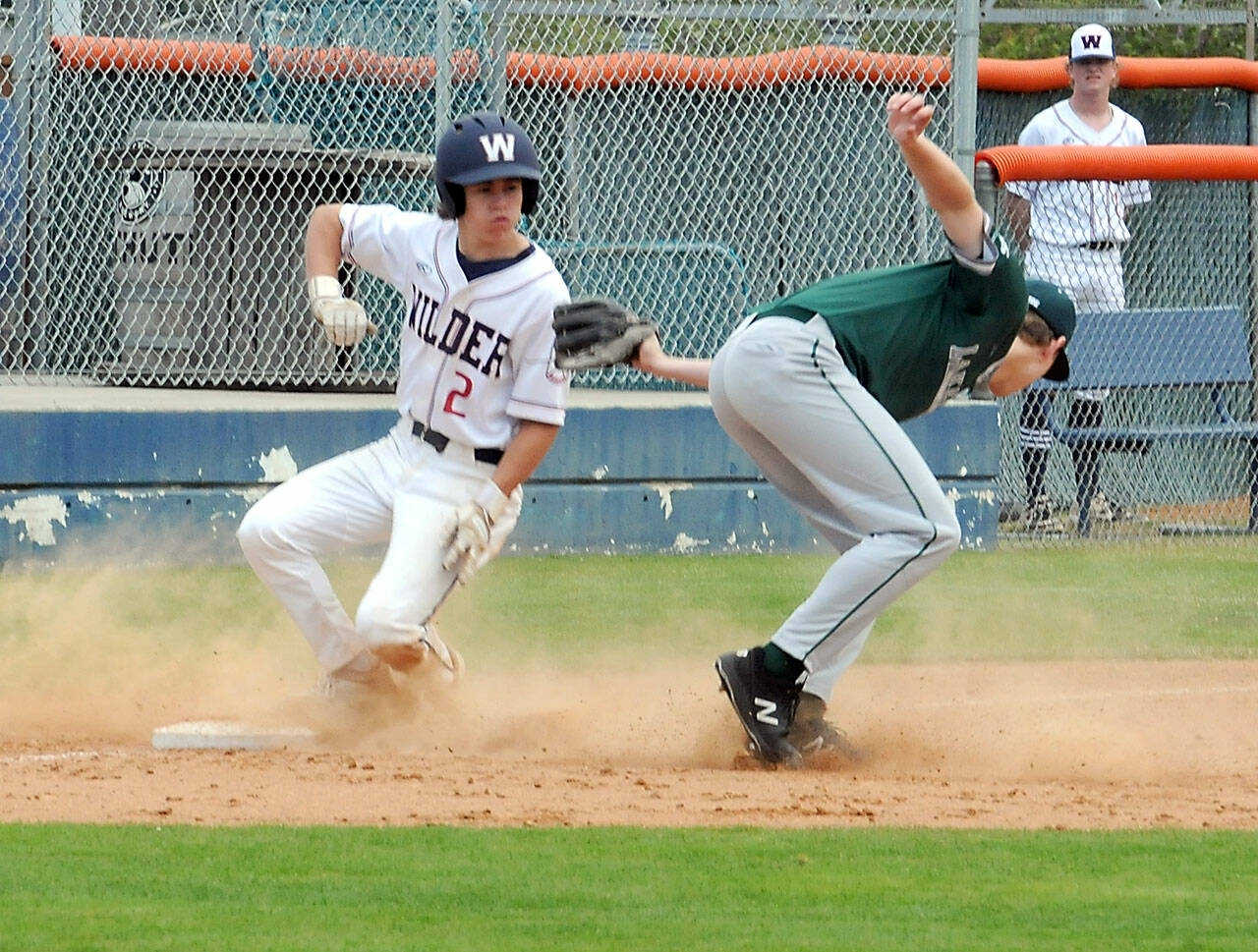 Wilder Senior’s Alex Angevine, left, makes it to third as Lakeside Recovery Senior third baseman Carter DuBreuil struggles with an errant throw on Saturday afternoon at Port Angeles Civic Field. (Keith Thorpe/Peninsula Daily News)