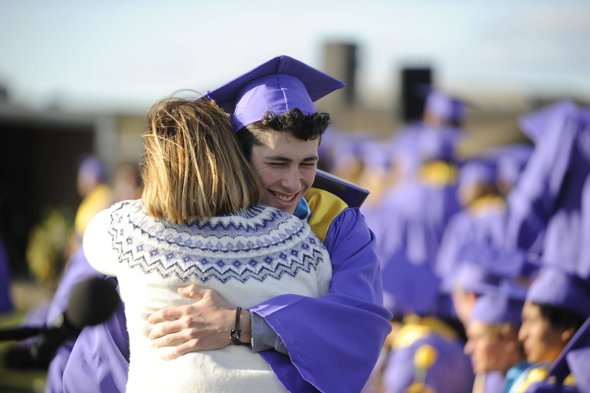 Michael Dashiell / Olympic Peninsula News Group
Graduating senior Ayden Humphries gets a hug from school board member Patrice Johnston at the Sequim High School commencement ceremony on Friday.