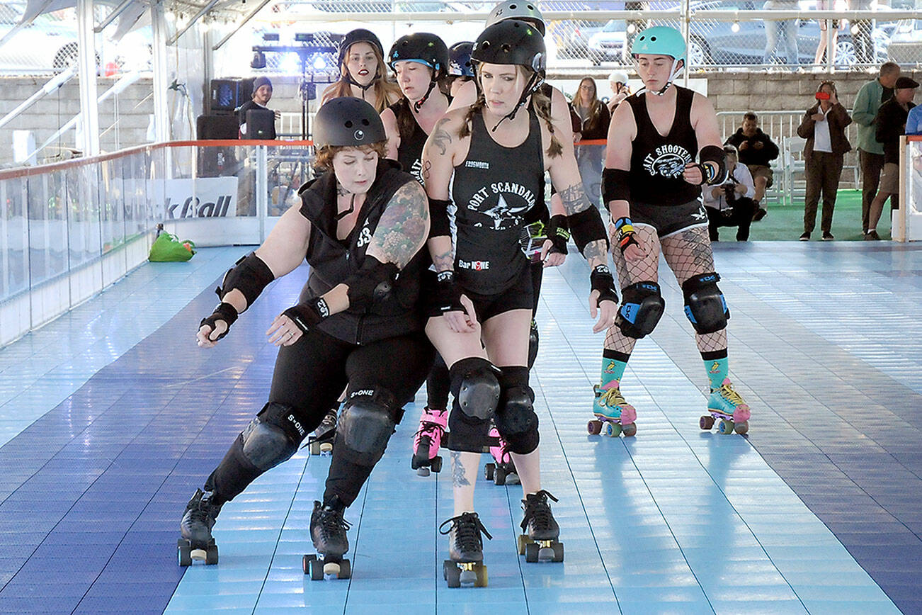 KEITH THORPE/PENINSULA DAILY NEWS
Port Scandalous Roller Derby team members Jamie "Ginger" Haire, front left, and Shauna "LilyHammer" Rogers-McClain, front right, bump into each other as the rest of their team follows in the pack during a demonstration skate on Thursday at the Olympic Skate Village in downtown Port Angeles. The demo was part of an opening celebration for the temporary roller skating rink, which opened for public skate sessions on Friday.