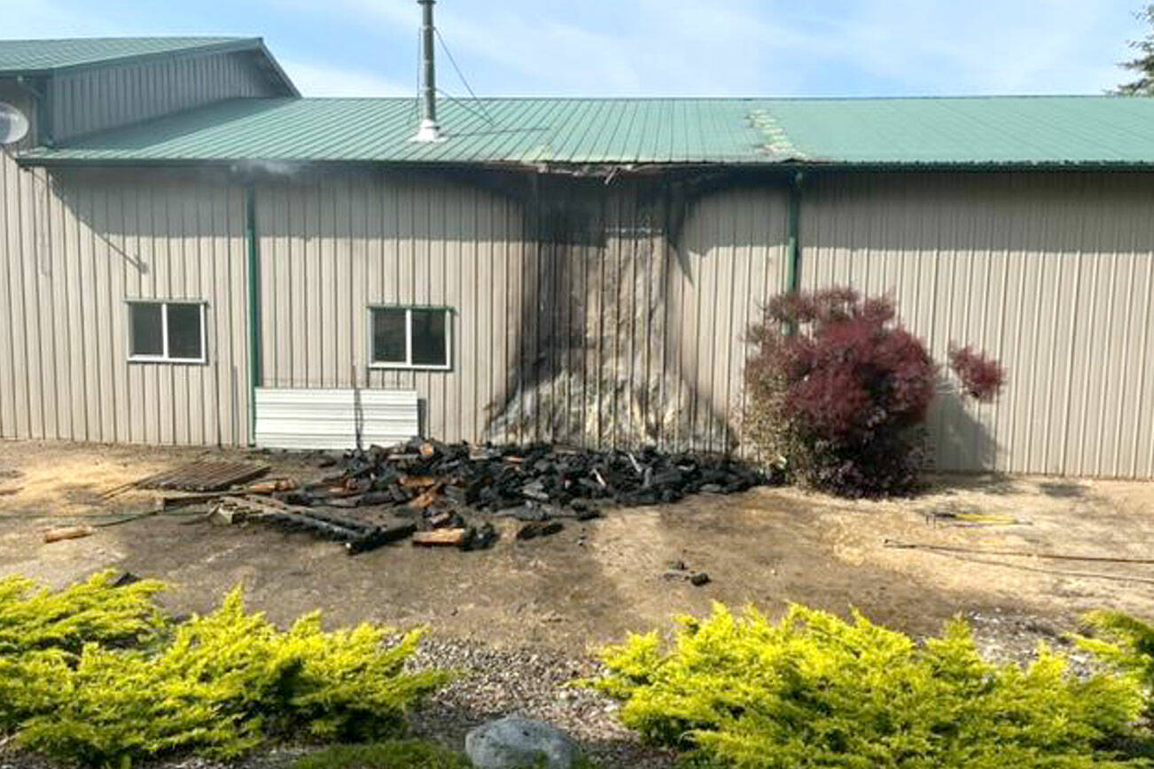 A fire destroyed a wood pile and damaged a large shed with an attached living area. (Chris Turner)