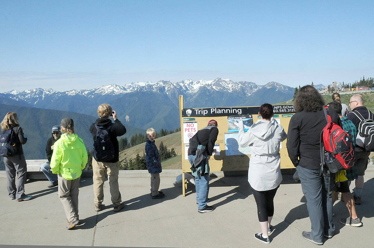 Hurricane Ridge visitors look out over the Olympic Mountains on Tuesday after the ridge was reopened in Olympic National Park. (Keith Thorpe/Peninsula Daily News)