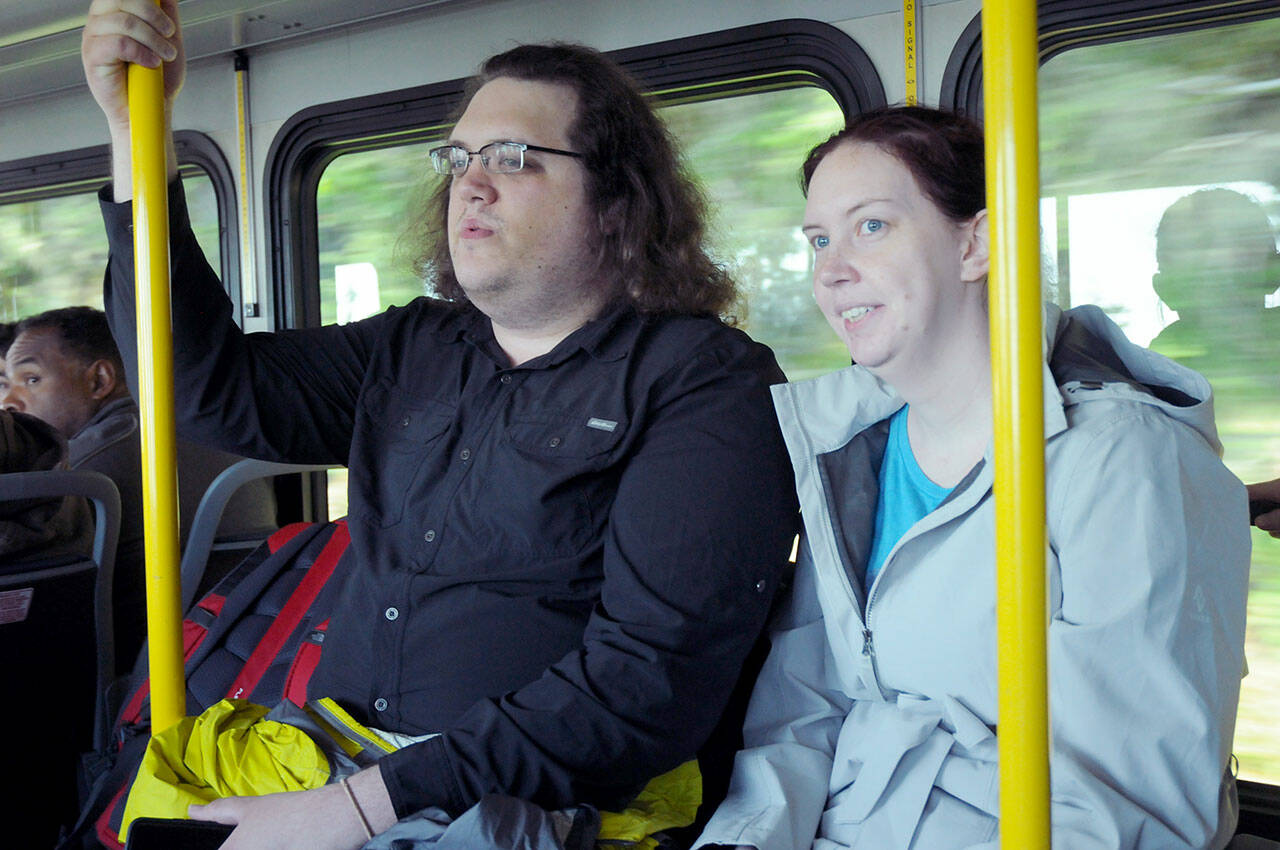 Aaron Neuhouse and Hope Foley, both of North St. Paul, Minn., take the inaugural ride on Clallam Transit from Port Angeles to Hurricane Ridge after the ridge was reopened to the public on Tuesday. (Keith Thorpe/Peninsula Daily News)