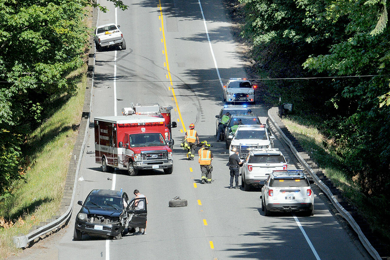 Emergency vehicles respond to the scene of a collision that closed a portion of U.S. Highway 101 near the Tumwater Truck Route east of Fairmount Avenue on Tuesday afternoon. (Keith Thorpe/Peninsula Daily News)