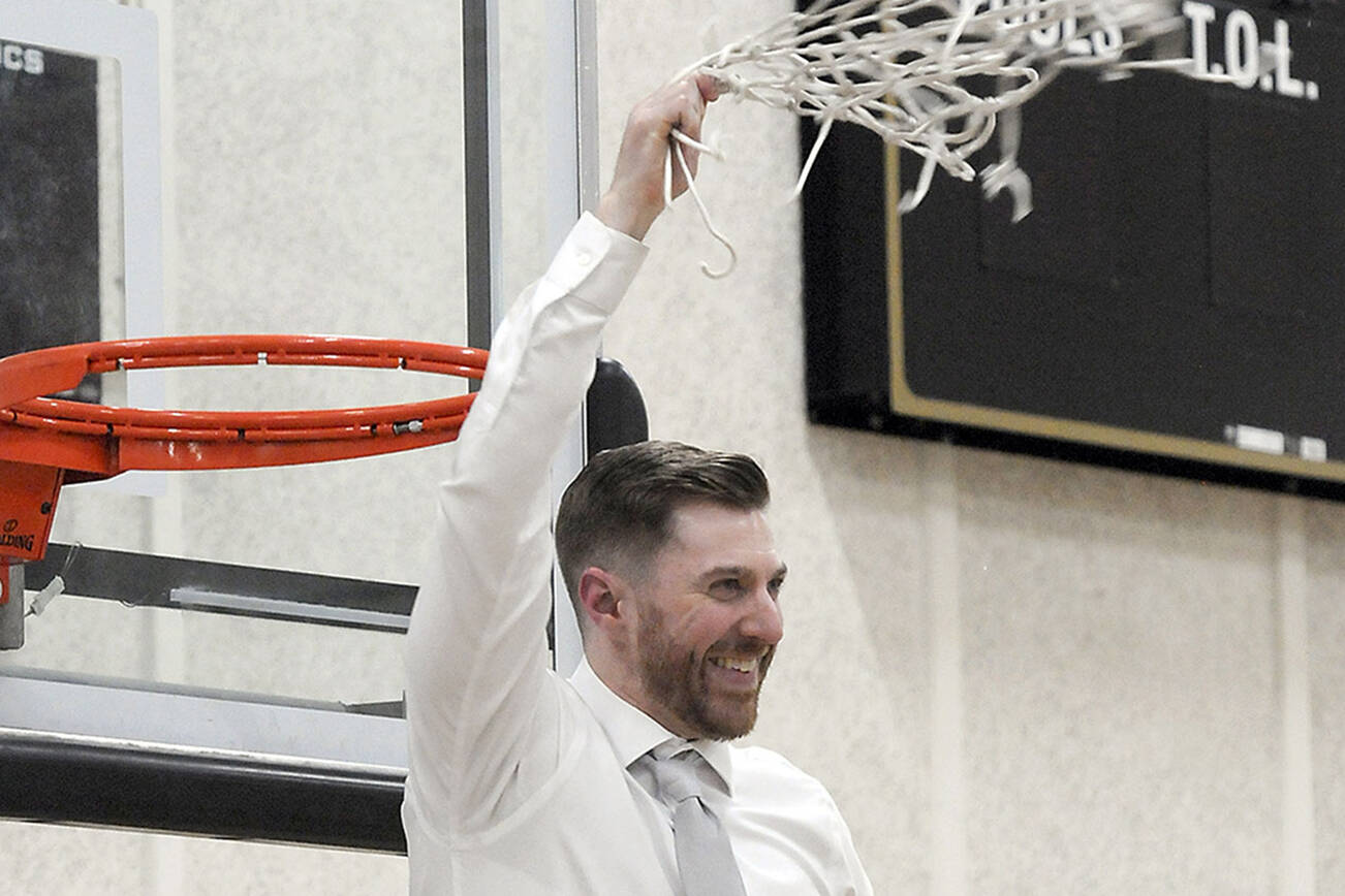 Keith Thorpe/Peninsula Daily News
Donald Rollman, head coach of the Peninsula Pirates mens team, waves a cut net in glory at the conclusion of Wednesday night's game against Everett with his team taking the NWAC North Region championship.