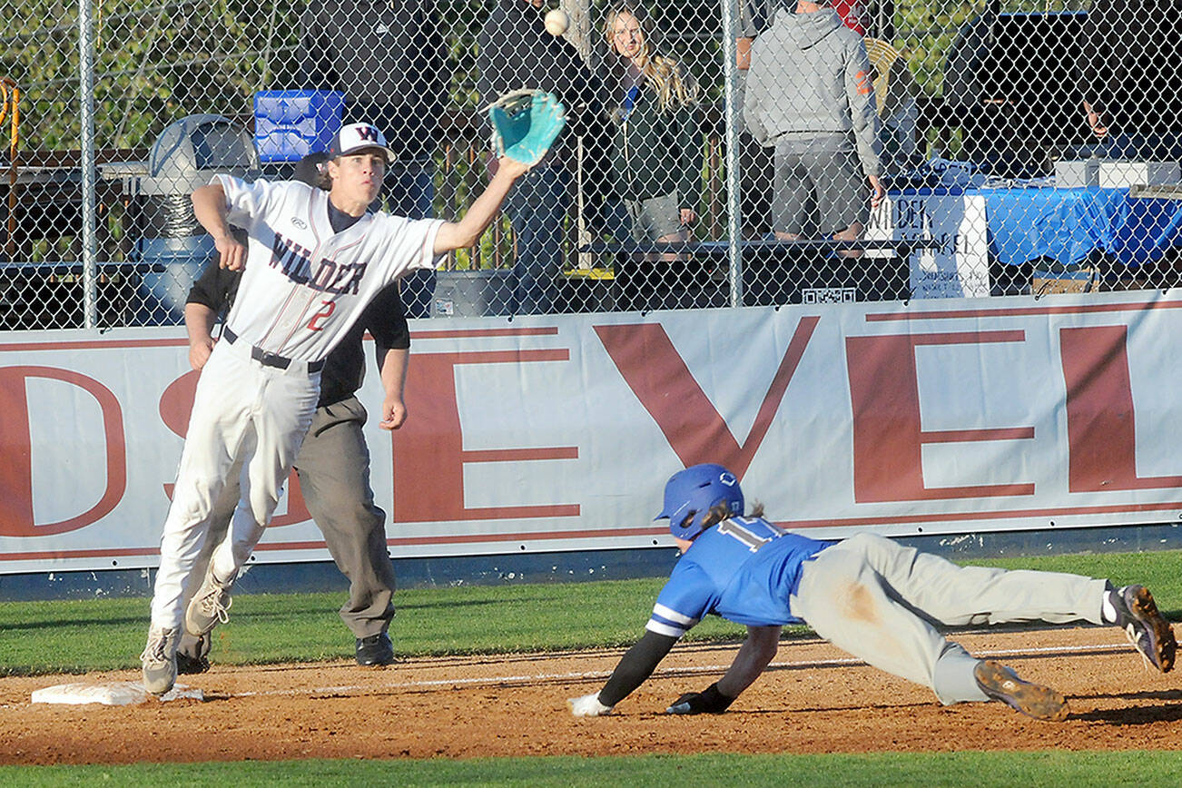 KEITH THORPE/PENINSULA DAILY NEWS
Wilder Senior shortstop Alex Angevine covers third base as Shoreline Royals runner Skylar Perry dives for the bag in the third inning on Thursday at Port Angeles Civic Field.