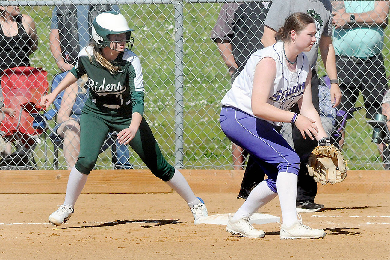 KEITH THORPE/PENINSULA DAILY NEWS
Port Angeles' Natalie Robinson, left, watches the pitch as Sequim first baseman Sammie Bacon keeps tabs during a May game in Port Angeles.